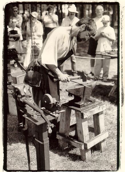 David at Orangeville, blacksmithing on double horn anvil, in period costume.